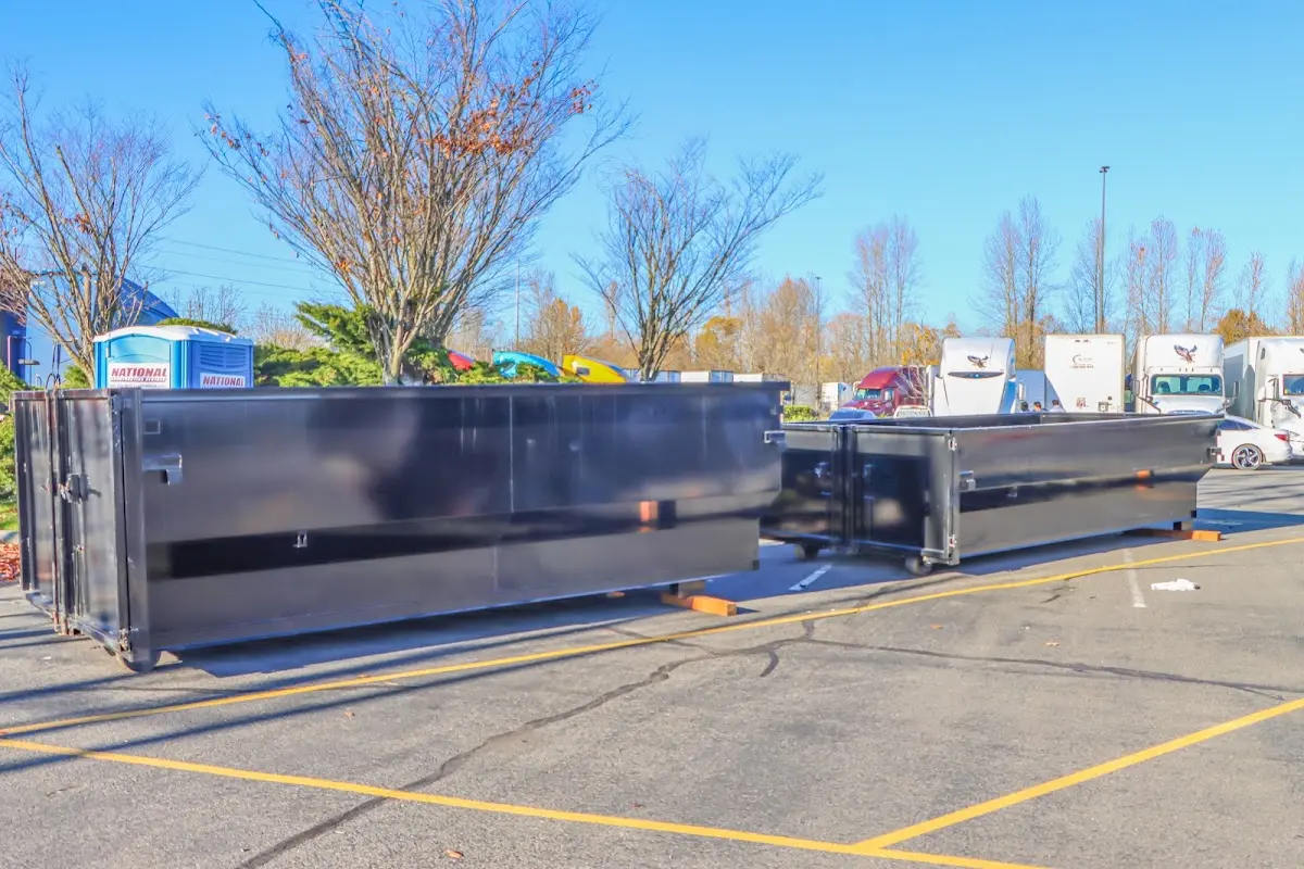 Professional dumpster rental service with roll-off container on residential driveway in Lynchburg
